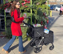 VOOMcart with stylish woman pushing a fully loaded VOOMcart with groceries and Christmas trees in the background